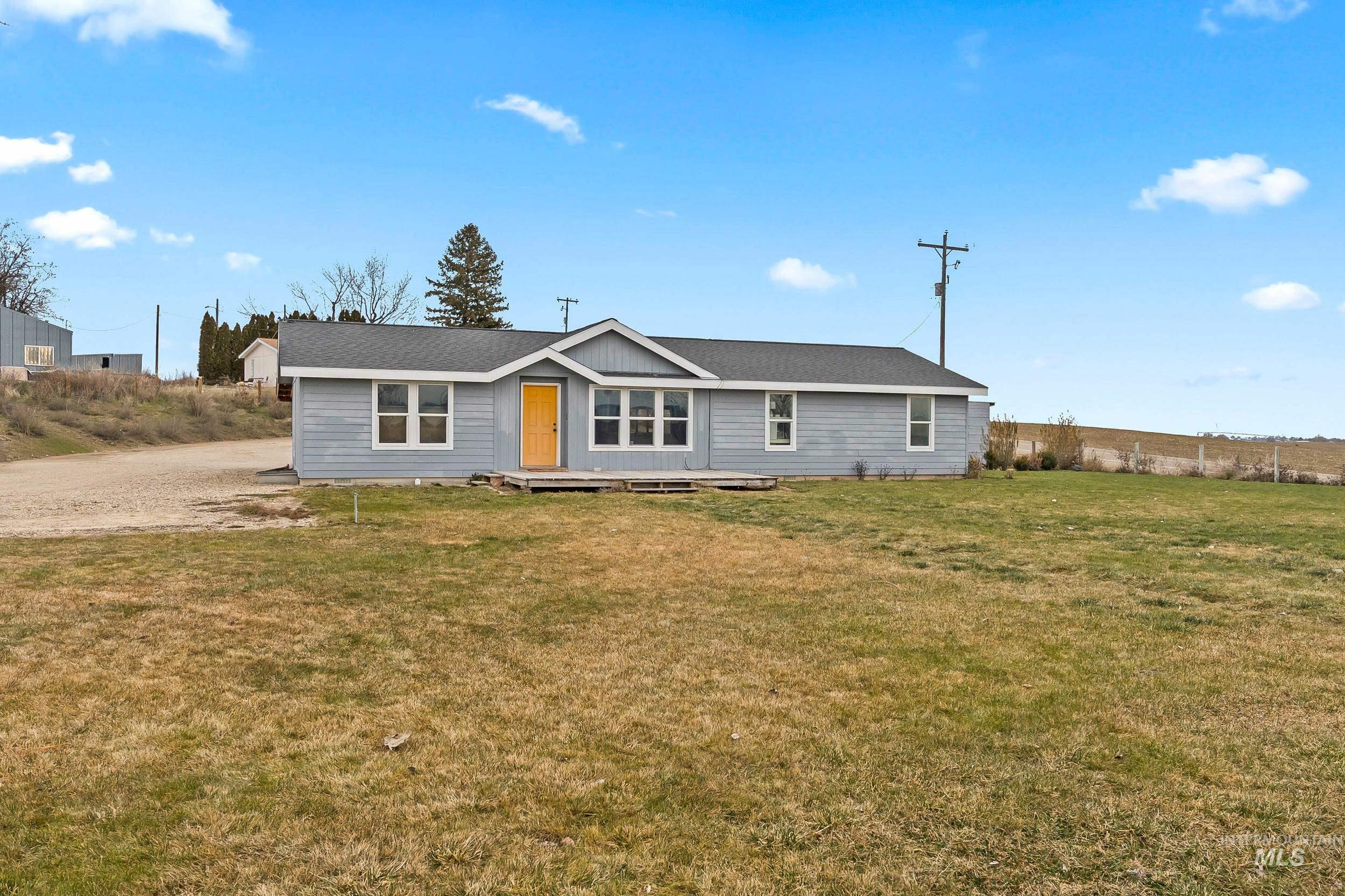 Ranch-style house featuring a front yard and a shingled roof