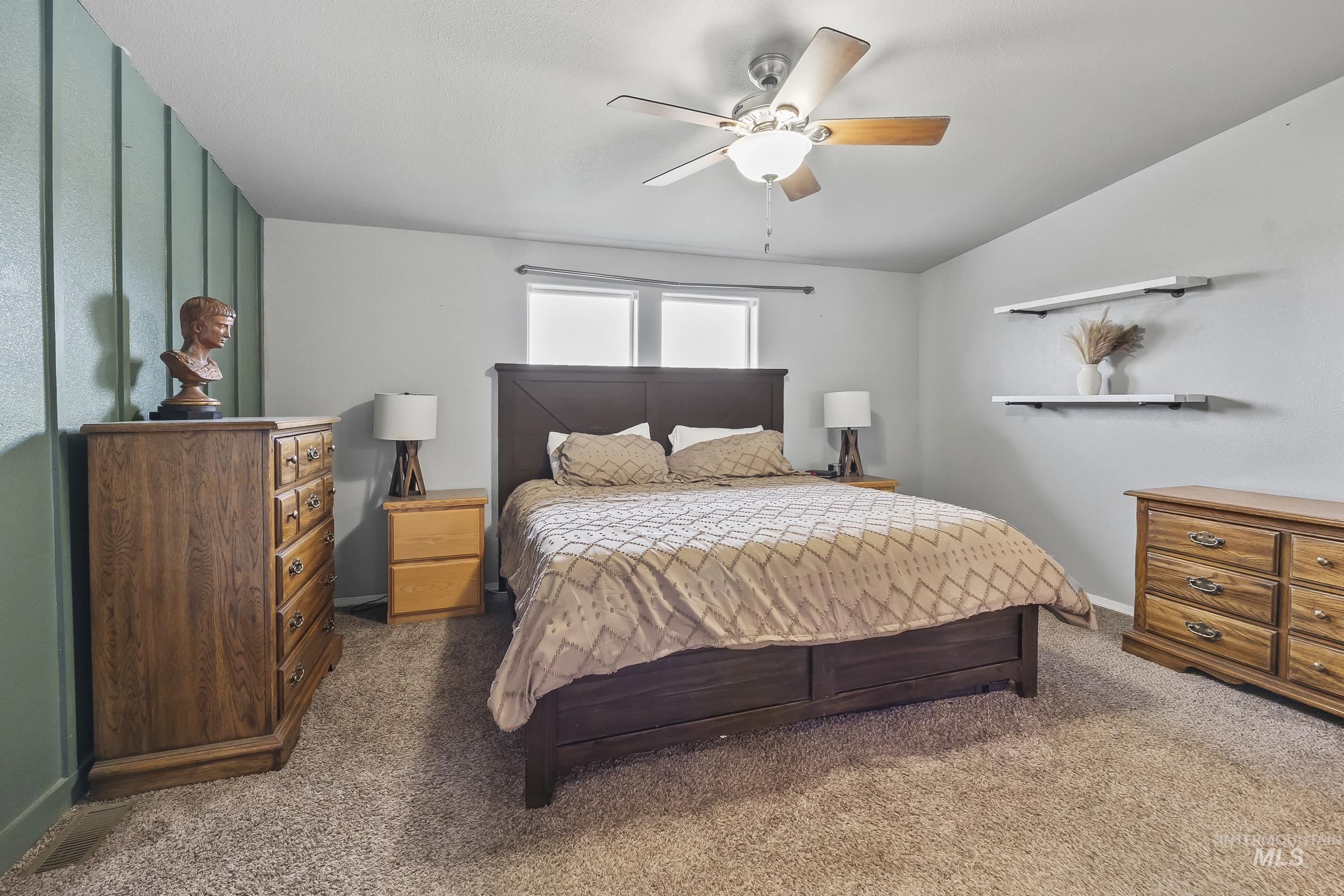 12944 Goodson Road Caldwell, ID 83607 - Photo 17 of 47 Bedroom featuring ceiling fan and carpet