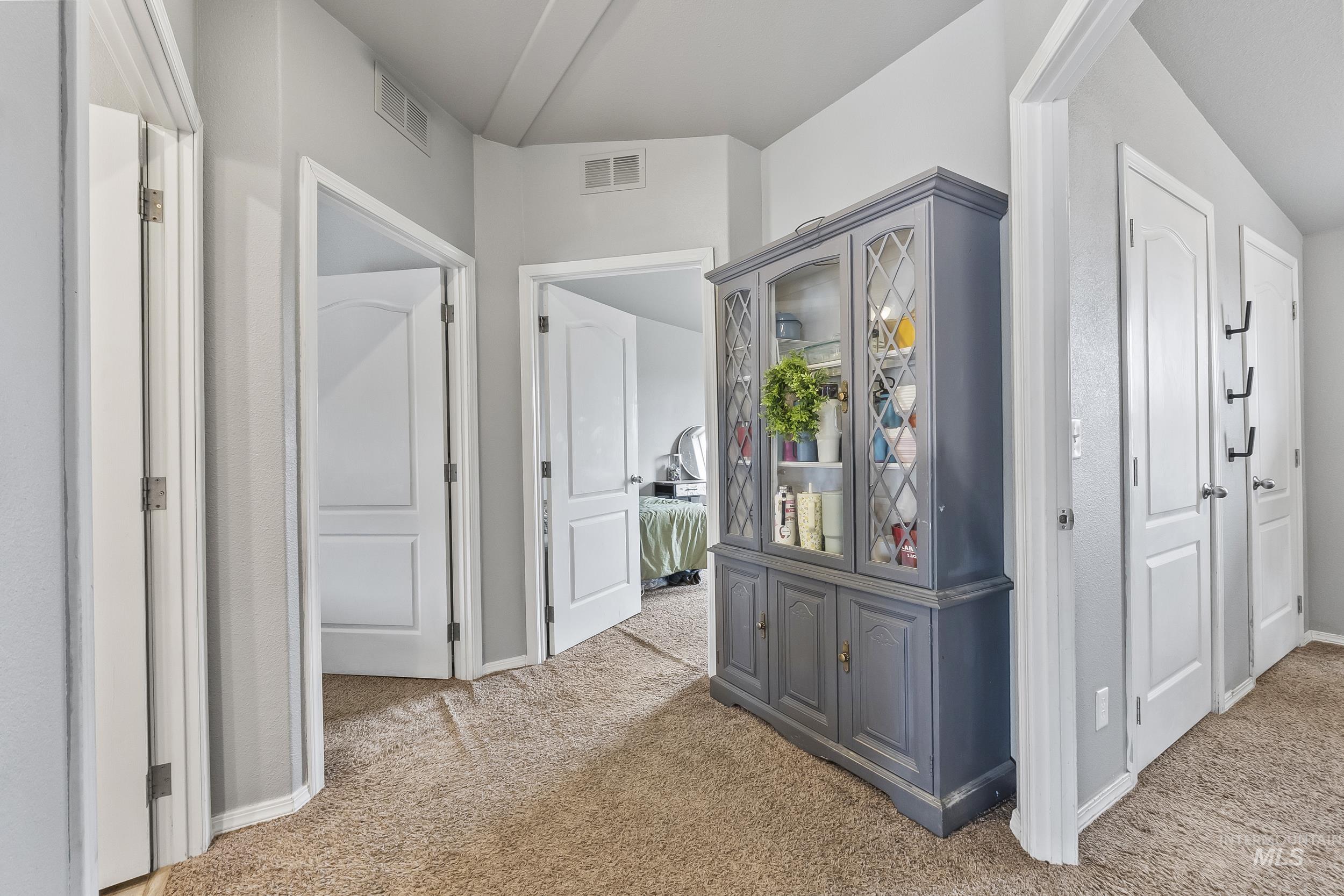 12944 Goodson Road Caldwell, ID 83607 - Photo 21 of 47 Hallway featuring light colored carpet and baseboards