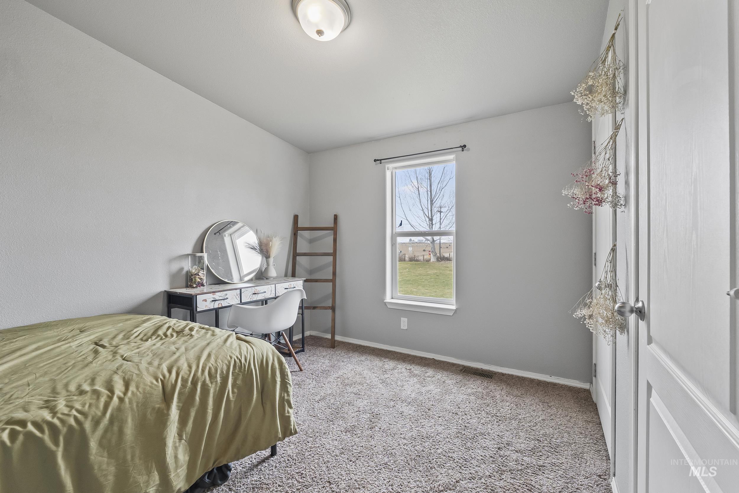 12944 Goodson Road Caldwell, ID 83607 - Photo 25 of 47 Carpeted bedroom with baseboards