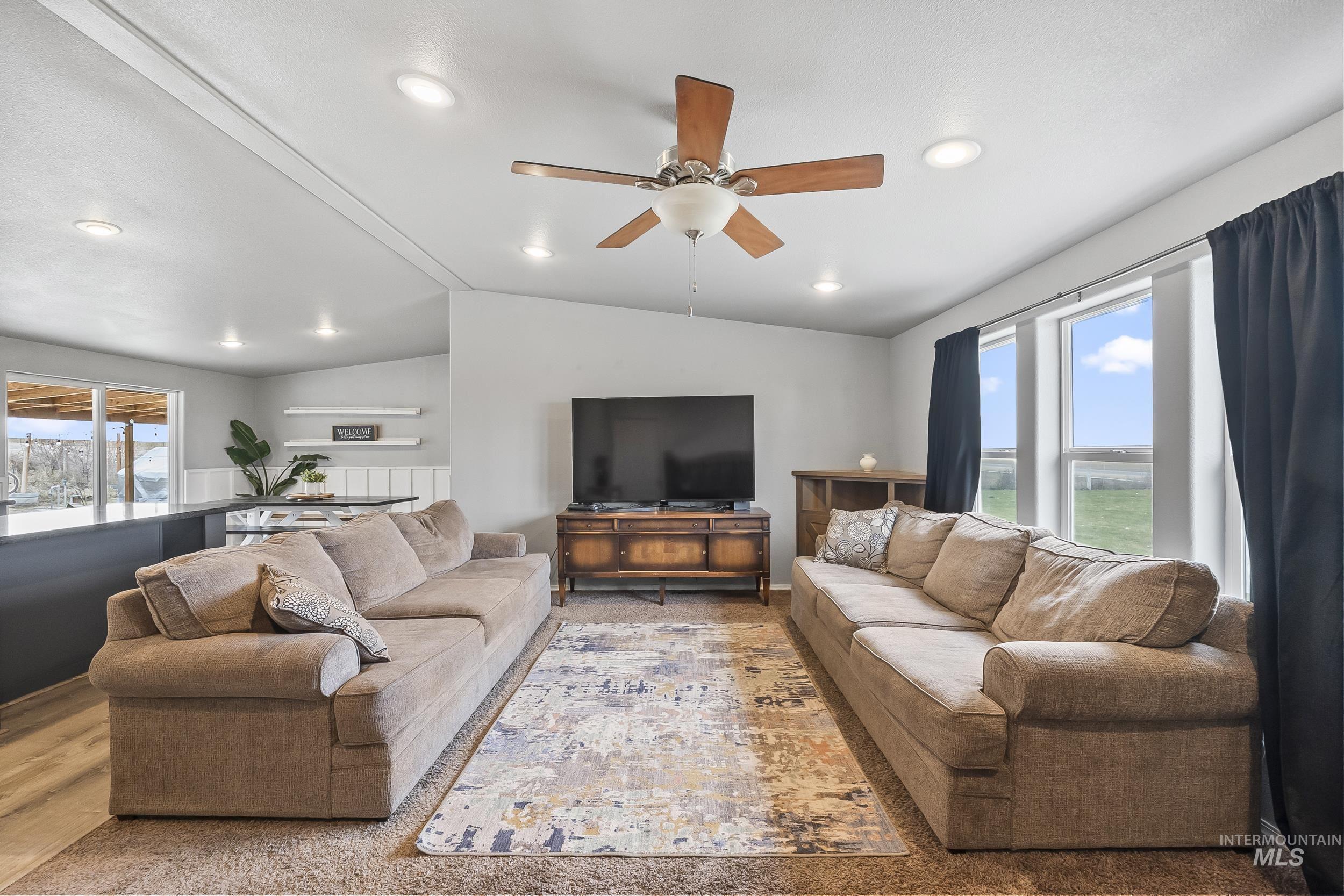 12944 Goodson Road Caldwell, ID 83607 - Photo 9 of 47 Living room with vaulted ceiling, ceiling fan, wood finished floors, and recessed lighting