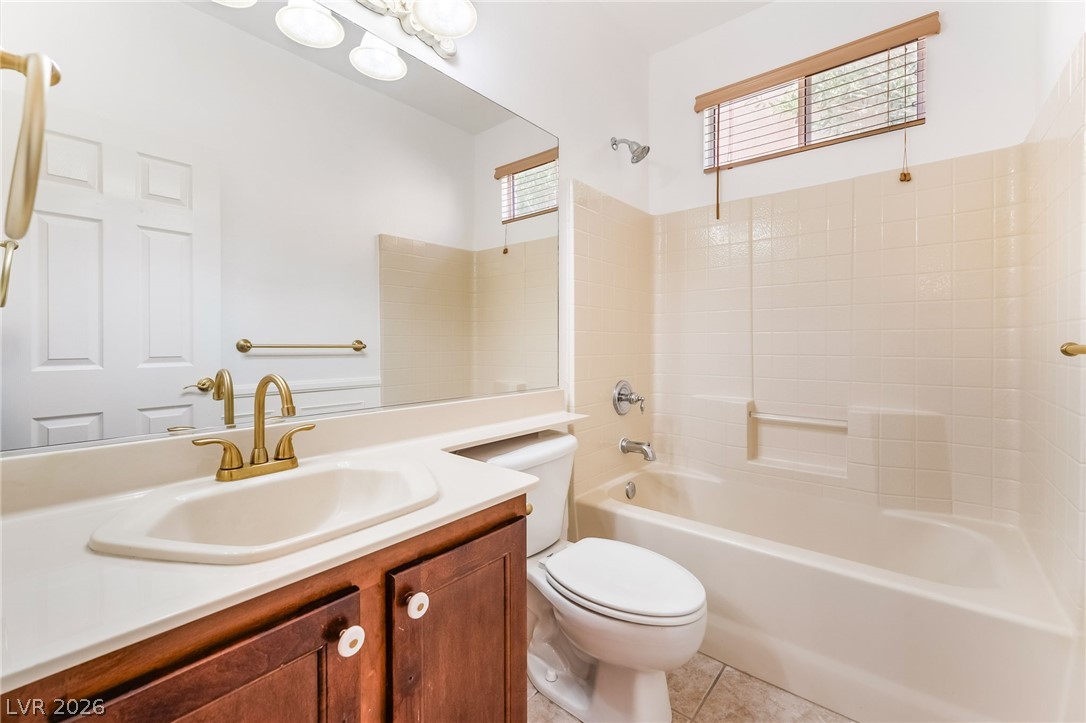 5389 Progresso Street Las Vegas, NV 89135 - Photo 18 of 41 A tidy bathroom features a full bath with shower, tile flooring, and a vanity with a large mirror.