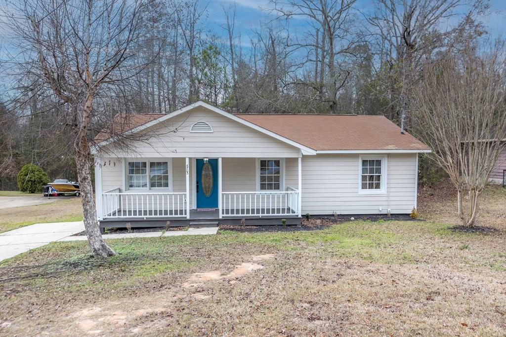 a front view of a house with a garden