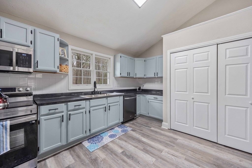 6703 Aldora Drive Columbus, GA 31907 - Photo 11 of 25 a kitchen with granite countertop white cabinets and white appliances