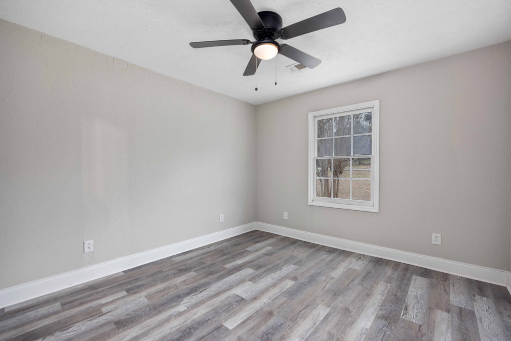 6703 Aldora Drive Columbus, GA 31907 - Photo 20 of 25 an empty room with a window and a ceiling fan