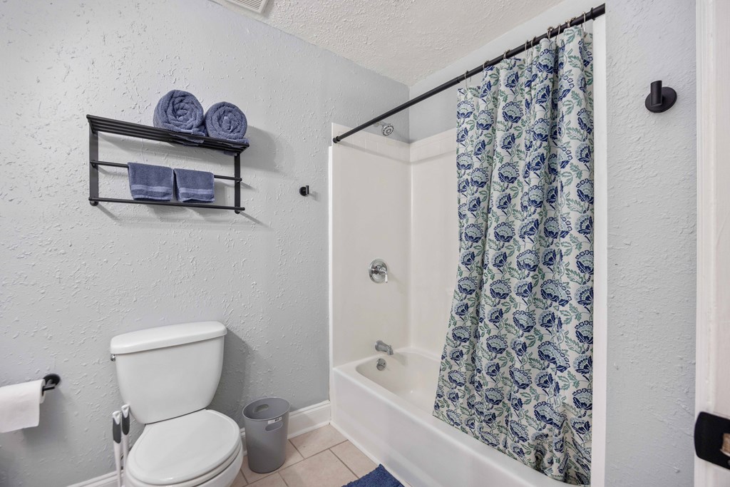 6703 Aldora Drive Columbus, GA 31907 - Photo 21 of 25 a bathroom with a toilet and a shower curtain