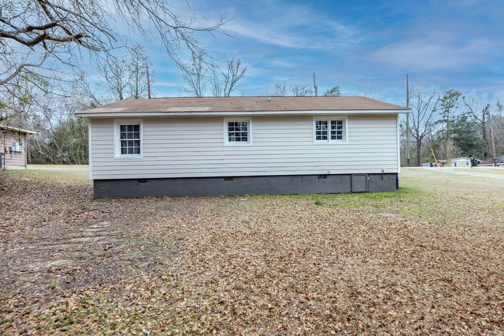 6703 Aldora Drive Columbus, GA 31907 - Photo 24 of 25 a view of a house that has a small yard and large trees