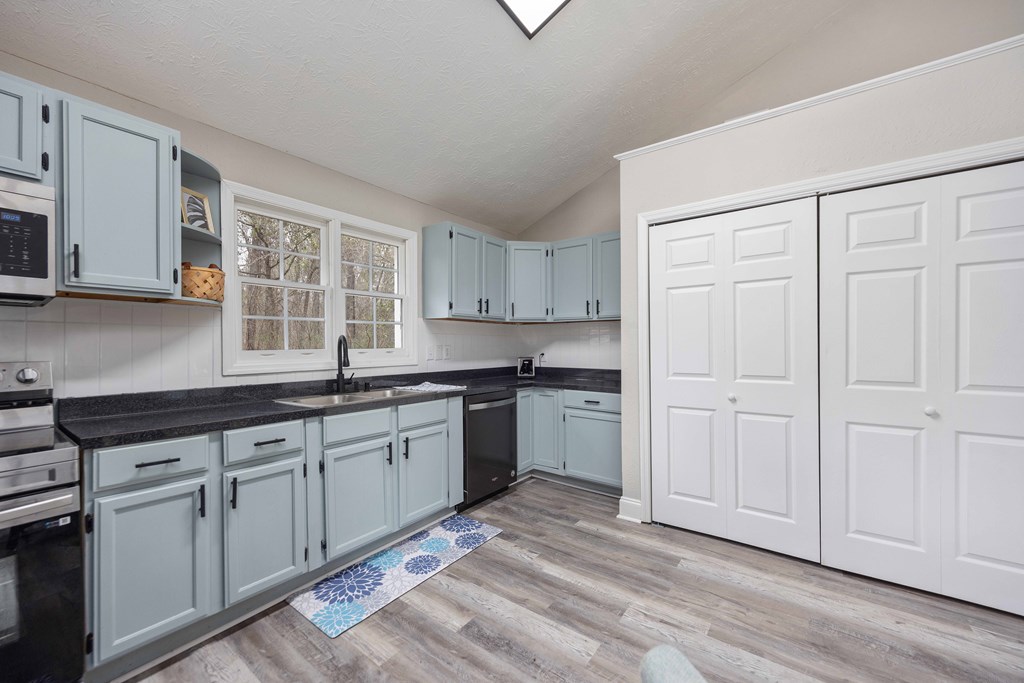 6703 Aldora Drive Columbus, GA 31907 - Photo 6 of 25 a kitchen with granite countertop white cabinets and stainless steel appliances