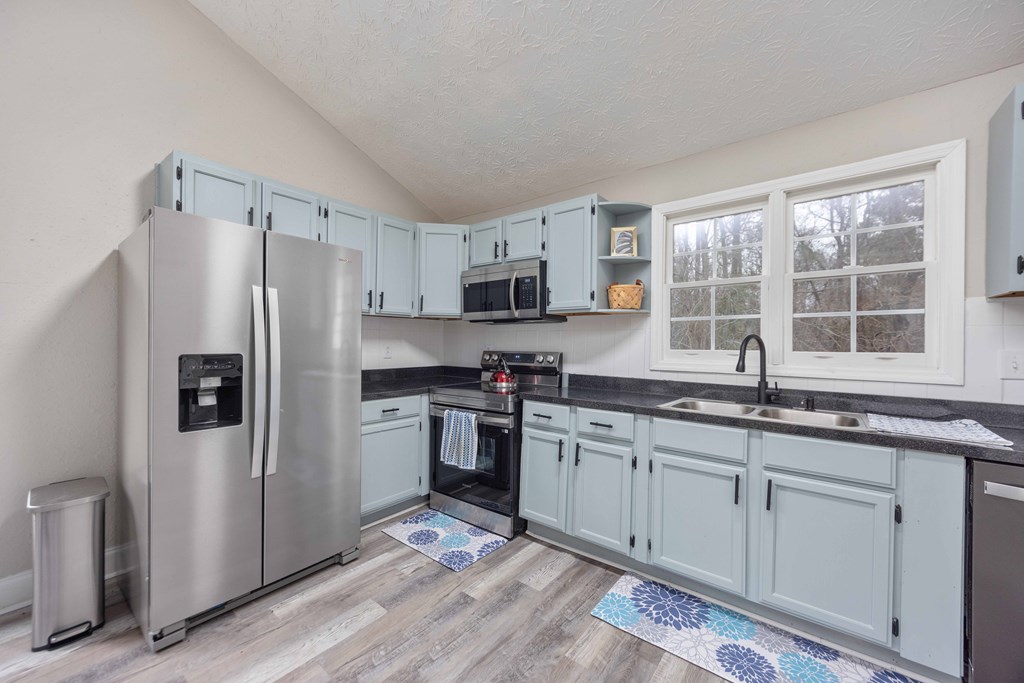 6703 Aldora Drive Columbus, GA 31907 - Photo 8 of 25 a kitchen with granite countertop a sink stainless steel appliances and window