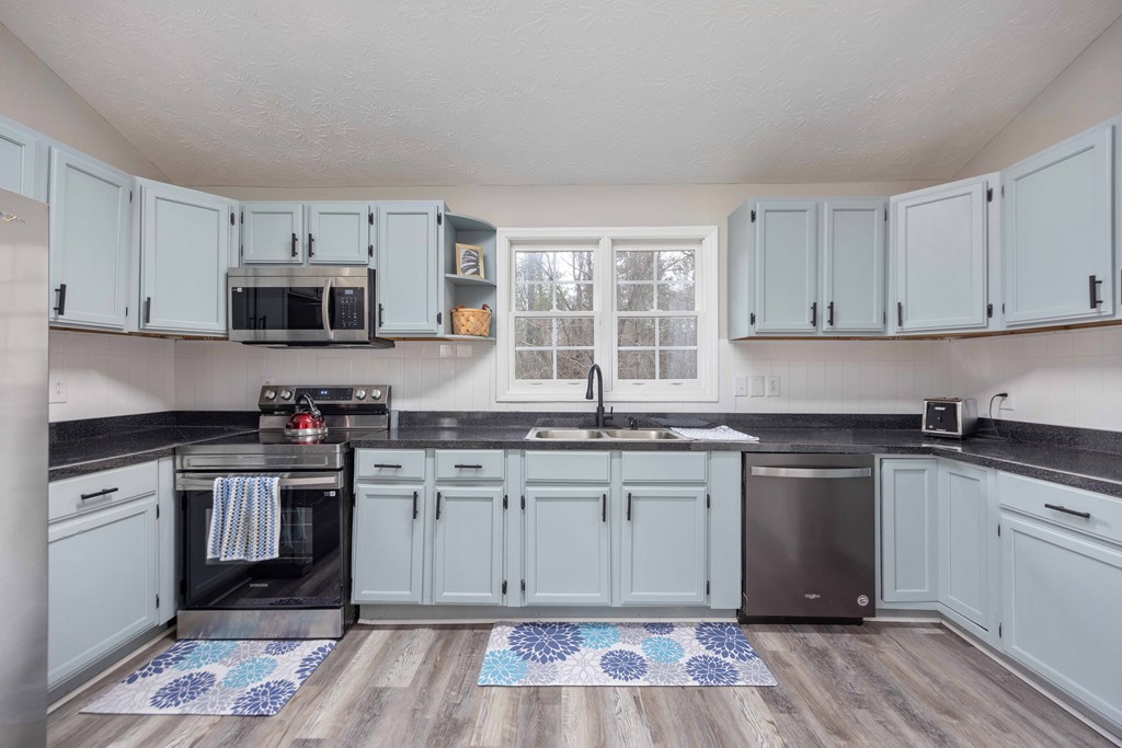 6703 Aldora Drive Columbus, GA 31907 - Photo 9 of 25 a kitchen with stainless steel appliances granite countertop a stove and a sink