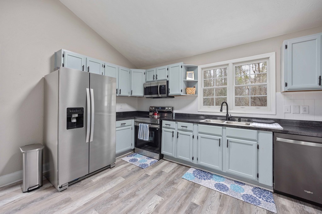 6703 Aldora Drive Columbus, GA 31907 - Photo 10 of 25 a kitchen with granite countertop a refrigerator stove top oven and sink