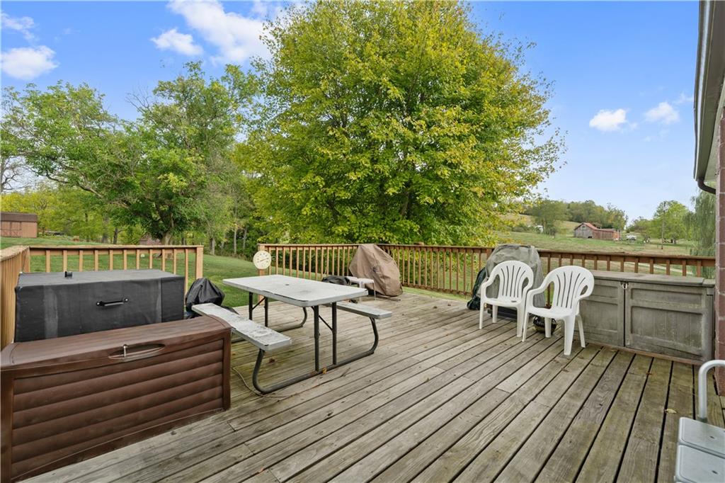 499 Old Post Road Prosperity, PA 15329 - Photo 6 of 45 a view of a roof deck with table and chairs a barbeque with wooden floor and fence