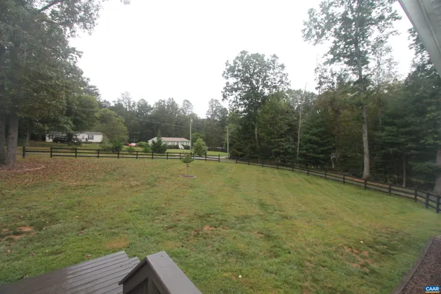 a view of outdoor space with deck and yard