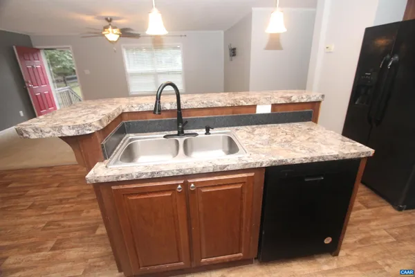 a bathroom with a granite countertop sink a mirror and vanity