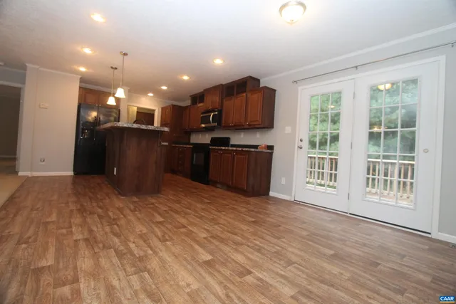 a view of kitchen with stainless steel appliances granite countertop lots of counter top space