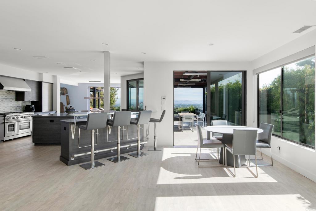2807 Caminito Turnberry La Jolla, CA 92037 - Photo 13 of 50 a living room with furniture a large window and kitchen view
