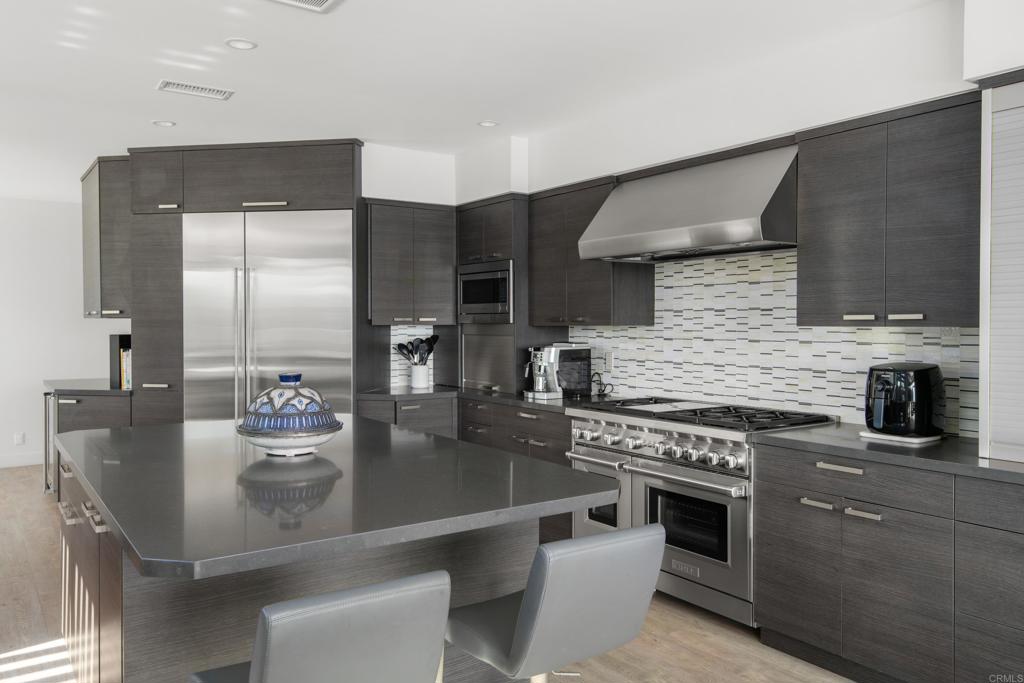 2807 Caminito Turnberry La Jolla, CA 92037 - Photo 16 of 50 a kitchen with stainless steel appliances granite countertop a stove and a refrigerator