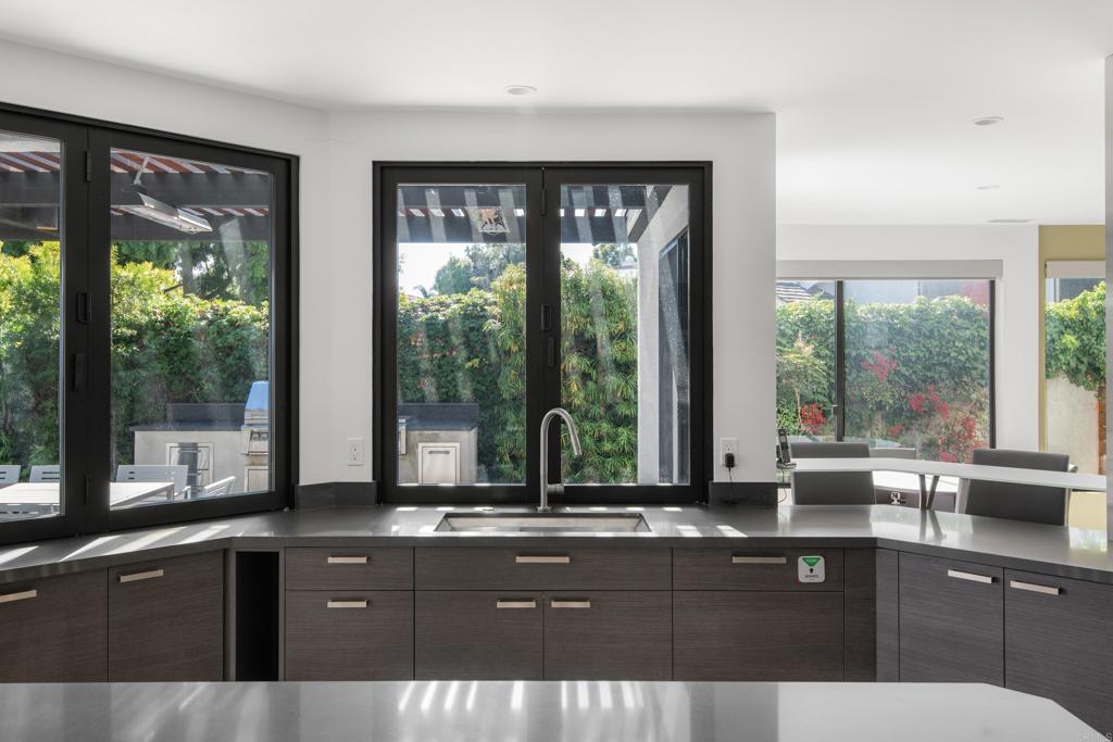 2807 Caminito Turnberry La Jolla, CA 92037 - Photo 17 of 50 a kitchen with granite countertop a sink and a large window