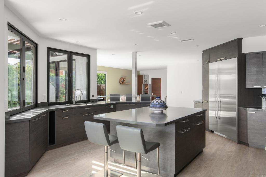 2807 Caminito Turnberry La Jolla, CA 92037 - Photo 18 of 50 a dining hall with stainless steel appliances granite countertop a sink a stove and refrigerator