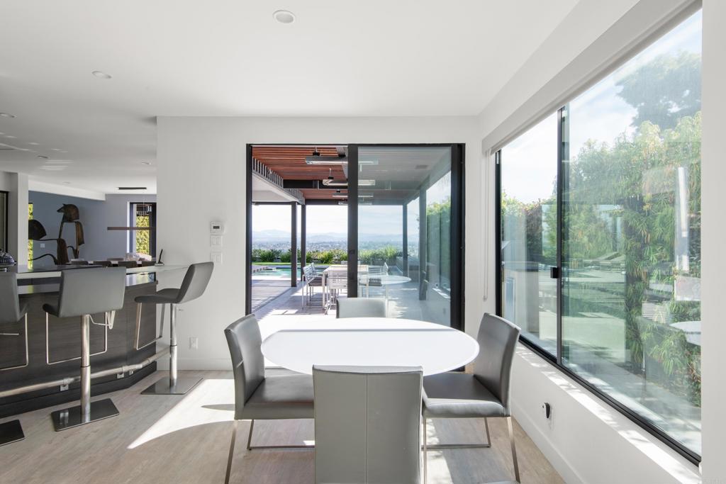 2807 Caminito Turnberry La Jolla, CA 92037 - Photo 20 of 50 a view of a dining room with furniture large windows and wooden floor