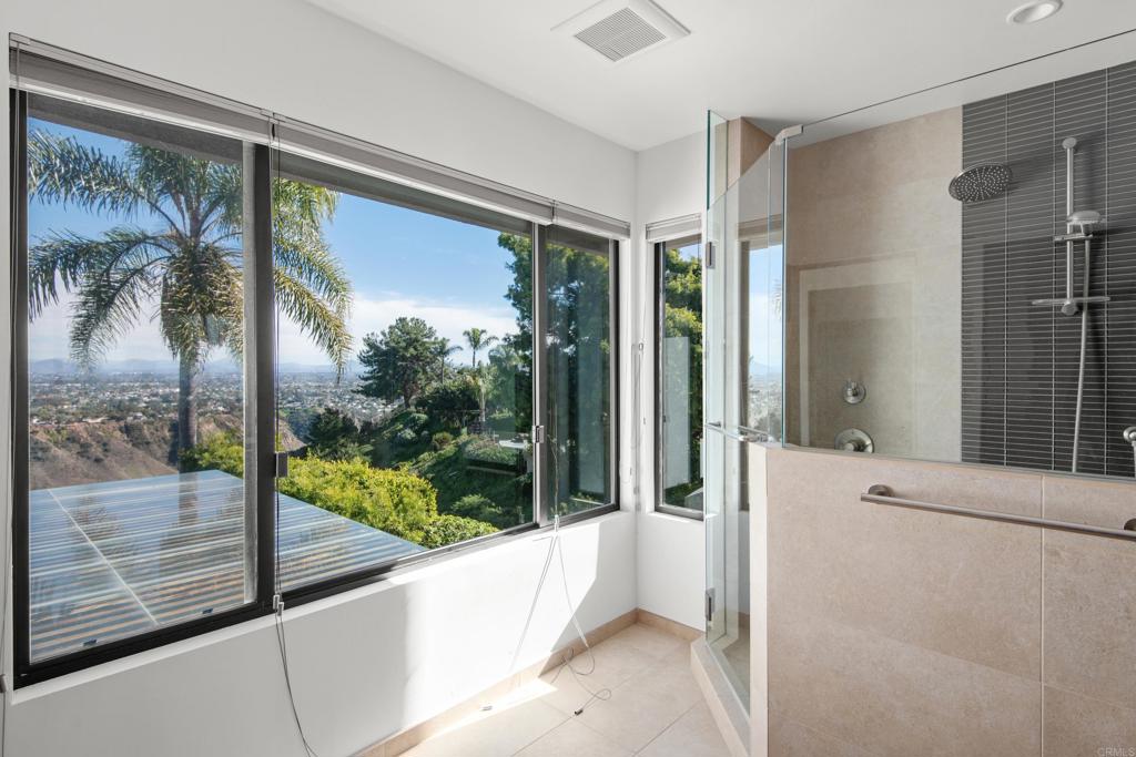 2807 Caminito Turnberry La Jolla, CA 92037 - Photo 36 of 50 a bathroom with a tub mirror and window