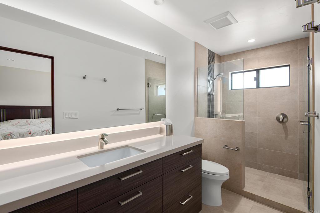 2807 Caminito Turnberry La Jolla, CA 92037 - Photo 39 of 50 a bathroom with a sink a toilet a shower and a mirror