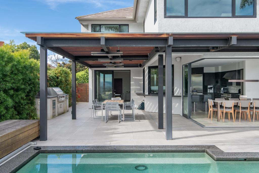 2807 Caminito Turnberry La Jolla, CA 92037 - Photo 4 of 50 a view of a patio with table and chairs potted plants with floor to ceiling window