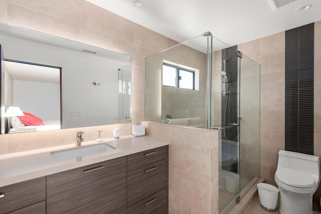 2807 Caminito Turnberry La Jolla, CA 92037 - Photo 41 of 50 a bathroom with a granite countertop sink toilet and shower