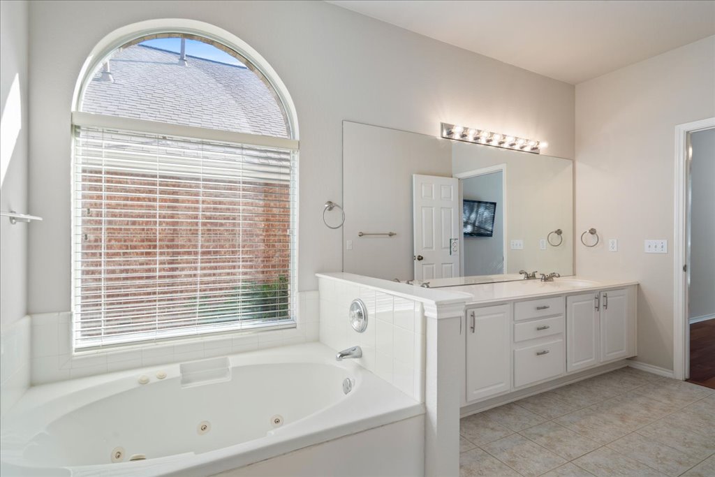10937 Colonel Winn Loop Austin, TX 78748 - Photo 11 of 36 a bathroom with a tub sink and mirror