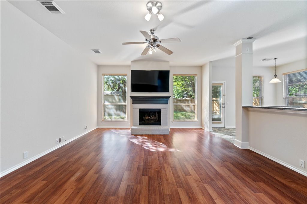 10937 Colonel Winn Loop Austin, TX 78748 - Photo 14 of 36 a living room with wooden floor and a fireplace