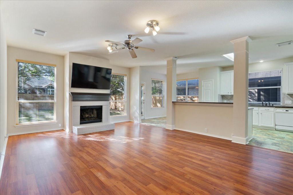 10937 Colonel Winn Loop Austin, TX 78748 - Photo 16 of 36 a view of a big room with wooden floor and a kitchen
