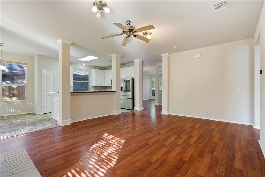 10937 Colonel Winn Loop Austin, TX 78748 - Photo 19 of 36 a view of a kitchen with wooden floor and a ceiling fan