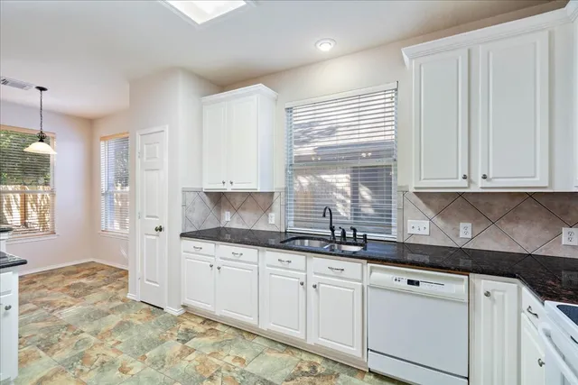 a view of a kitchen with wooden floor and a ceiling fan