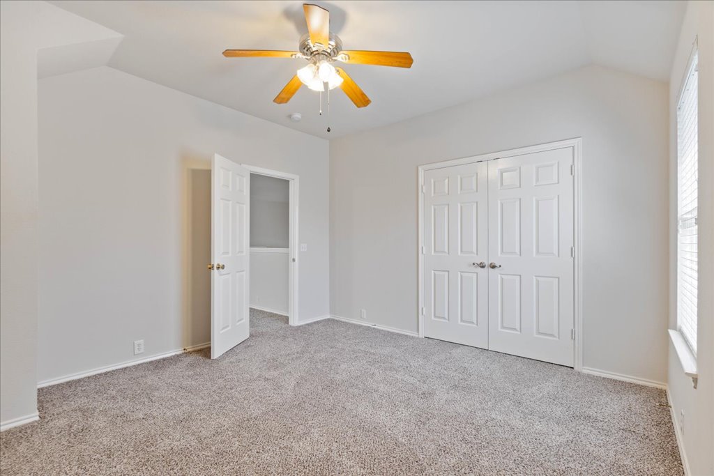 10937 Colonel Winn Loop Austin, TX 78748 - Photo 27 of 36 an empty room with closet and a chandelier fan