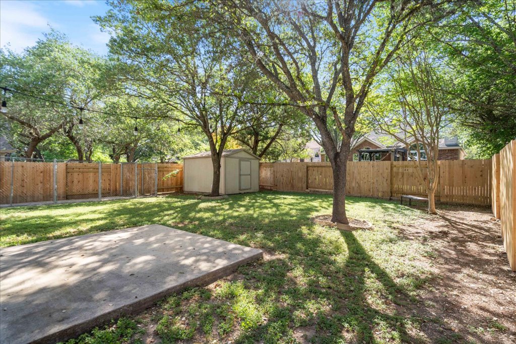 10937 Colonel Winn Loop Austin, TX 78748 - Photo 34 of 36 a backyard with wooden fence and a large tree