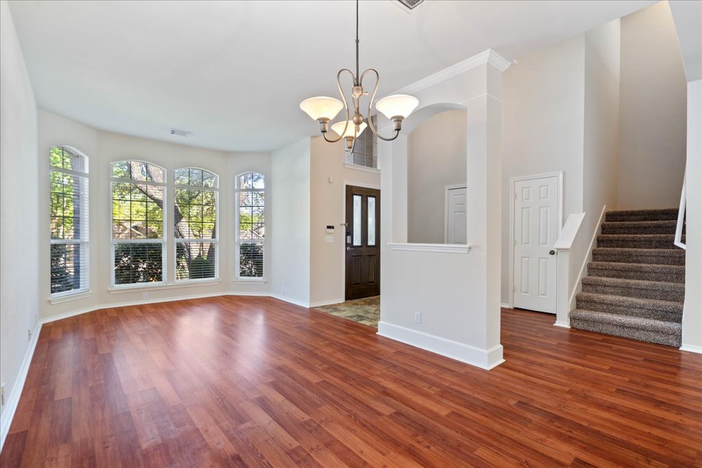 10937 Colonel Winn Loop Austin, TX 78748 - Photo 3 of 36 a view of an empty room with wooden floor and a window