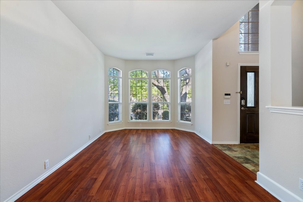 10937 Colonel Winn Loop Austin, TX 78748 - Photo 6 of 36 a view of an empty room with wooden floor and a window