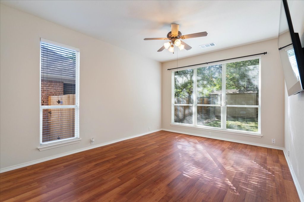 10937 Colonel Winn Loop Austin, TX 78748 - Photo 8 of 36 a view of an empty room with wooden floor and a window