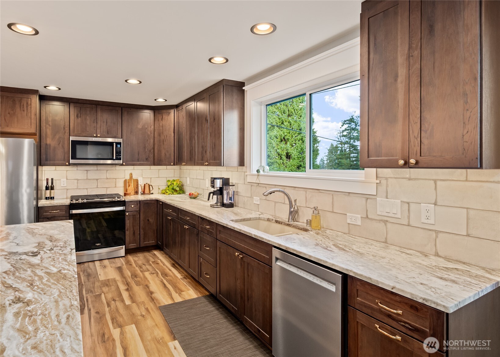 1726 63rd Street Southeast Everett, WA 98203 - Photo 11 of 37 a kitchen with stainless steel appliances granite countertop a sink counter space cabinets and a large window