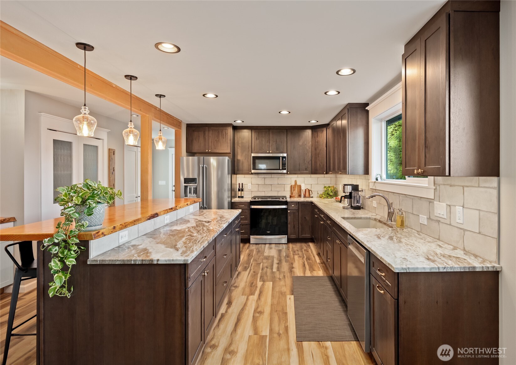 1726 63rd Street Southeast Everett, WA 98203 - Photo 8 of 37 a kitchen with granite countertop kitchen island sink stove and refrigerator