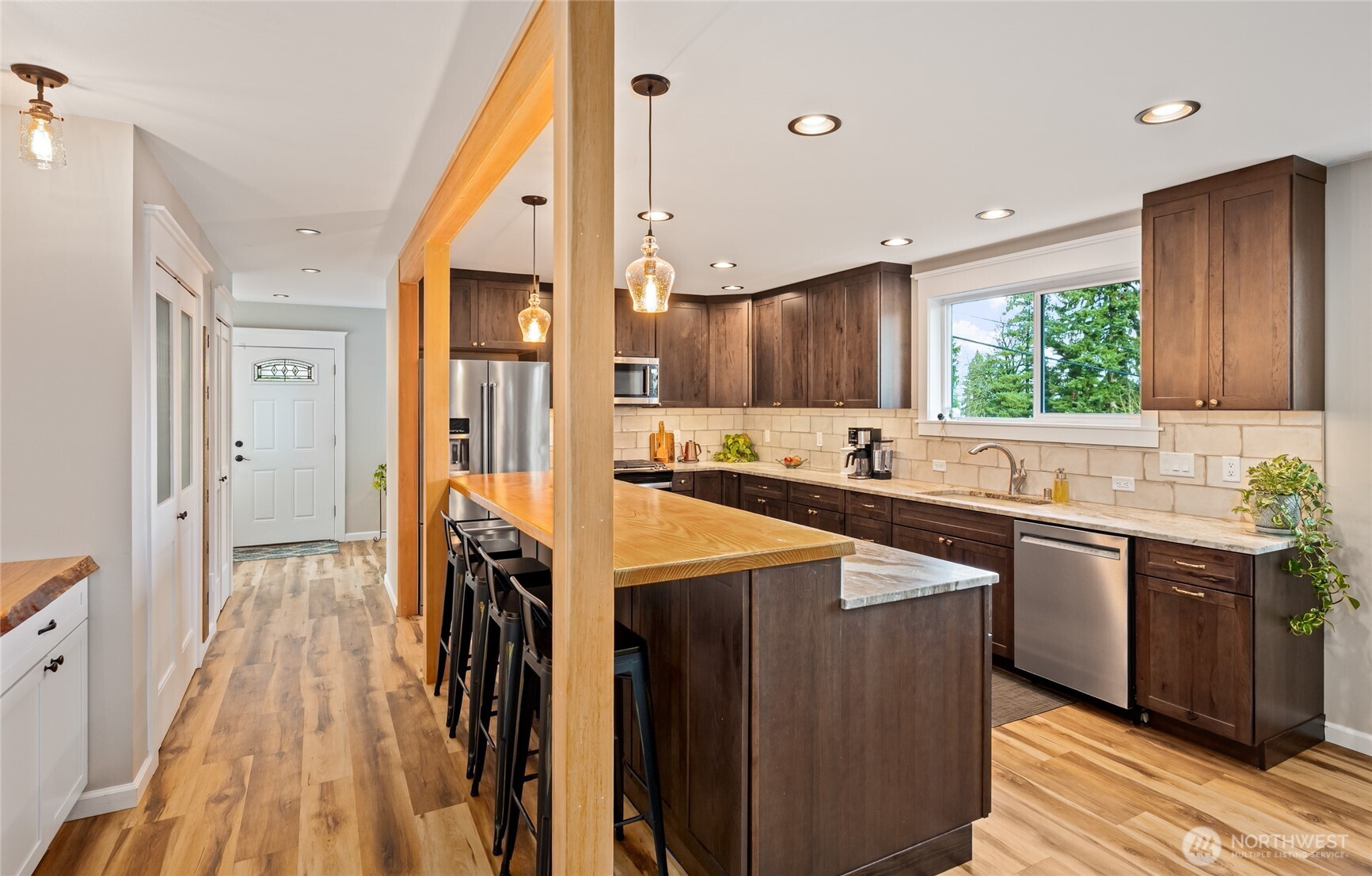 1726 63rd Street Southeast Everett, WA 98203 - Photo 9 of 37 a kitchen with stainless steel appliances granite countertop a refrigerator a sink dishwasher a stove and white countertops with wooden floor