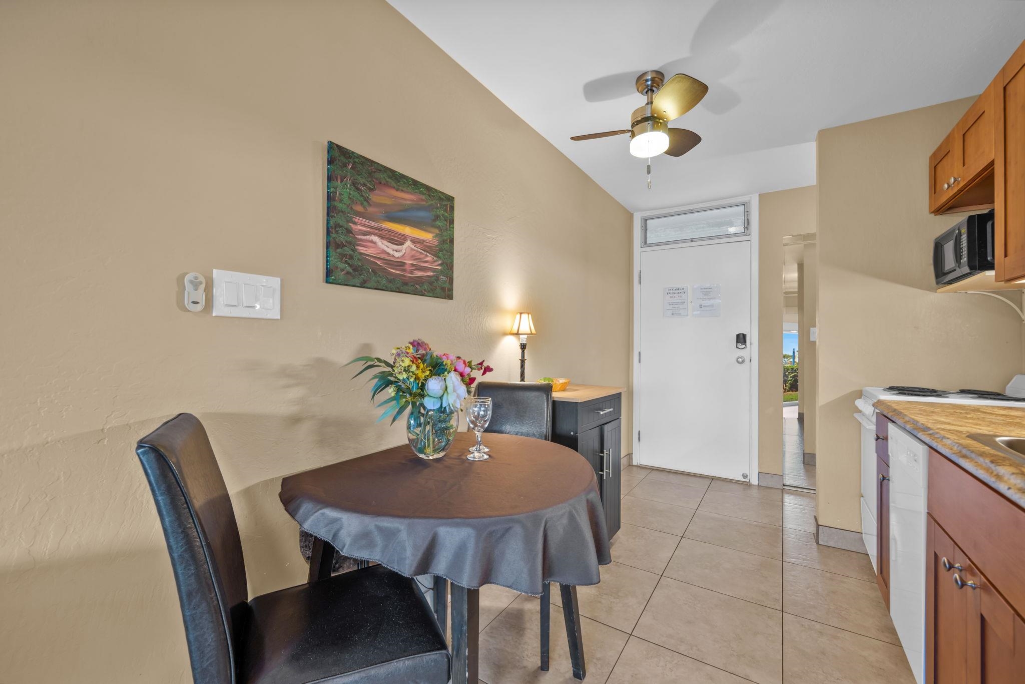 715 South Kihei Road, Unit 106 Kihei, HI 96753 - Photo 9 of 28 a view of a dining room with furniture and chandelier