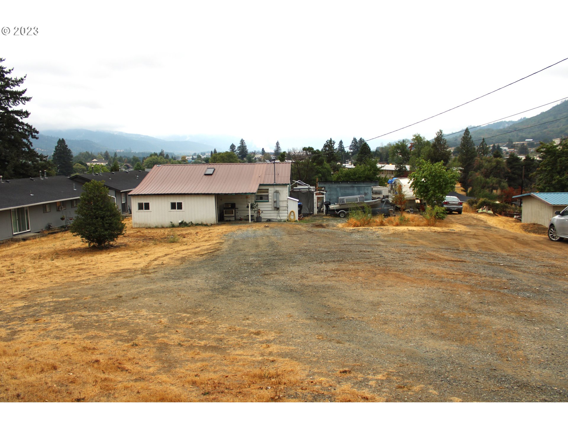 476 Smith Street Riddle, OR 97469 - Photo 1 of 16 a view of a house with a outdoor space