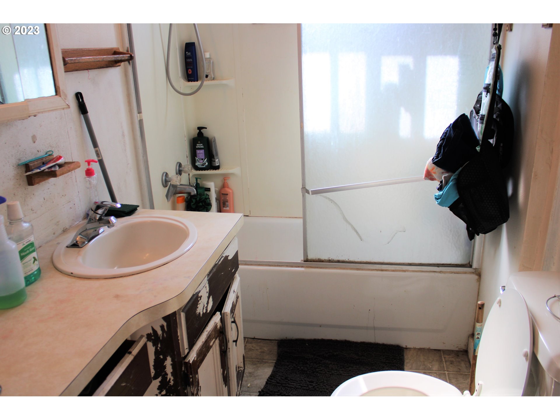 476 Smith Street Riddle, OR 97469 - Photo 11 of 16 a bathroom with a sink mirror and toilet