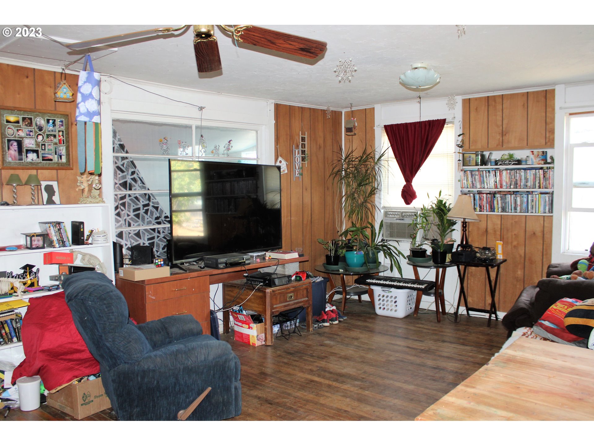 476 Smith Street Riddle, OR 97469 - Photo 3 of 16 a living room with furniture and a flat screen tv
