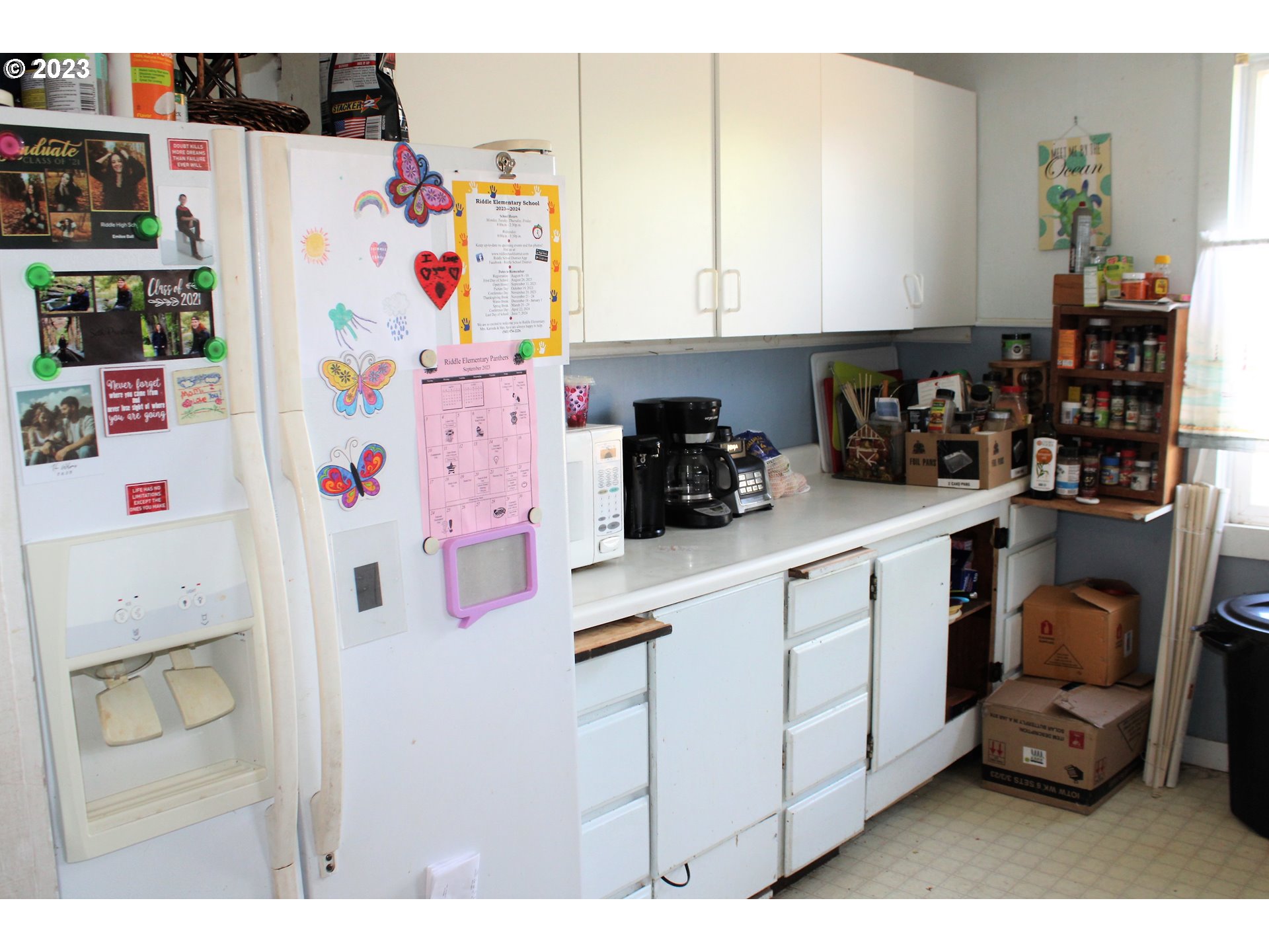 476 Smith Street Riddle, OR 97469 - Photo 9 of 16 a kitchen with a refrigerator and cabinets