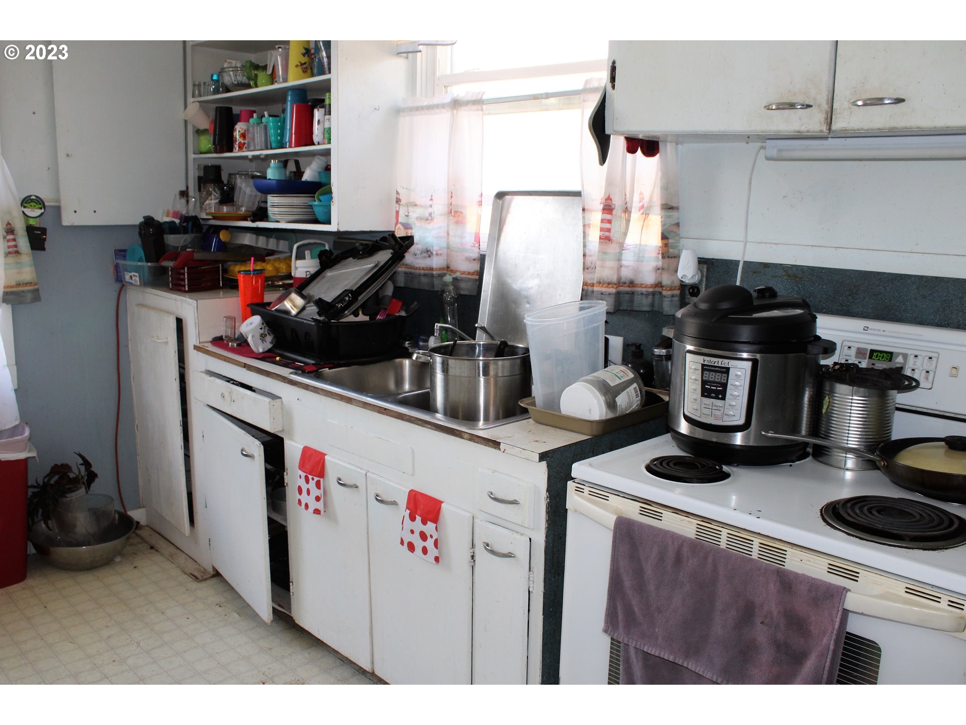 476 Smith Street Riddle, OR 97469 - Photo 10 of 16 a kitchen with a sink a stove and cabinets