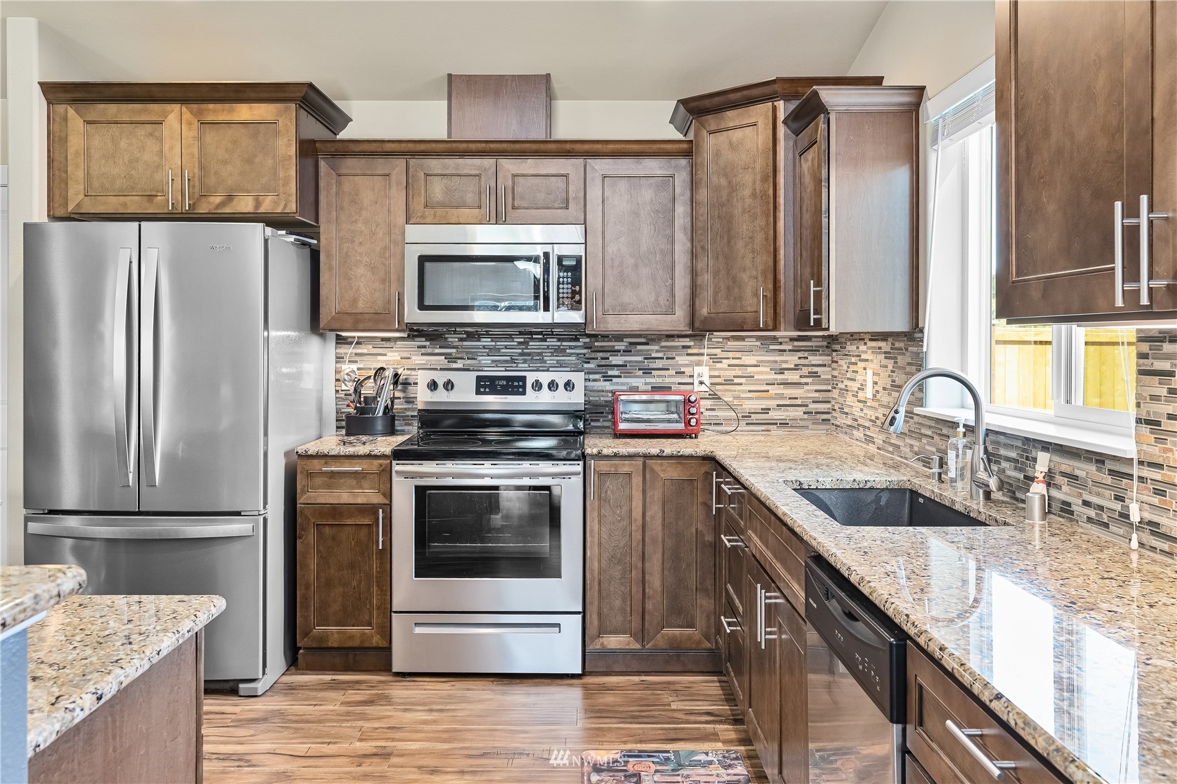 9249 179th Trail Southwest Rochester, WA 98579 - Photo 11 of 40 a kitchen with a sink stove and refrigerator