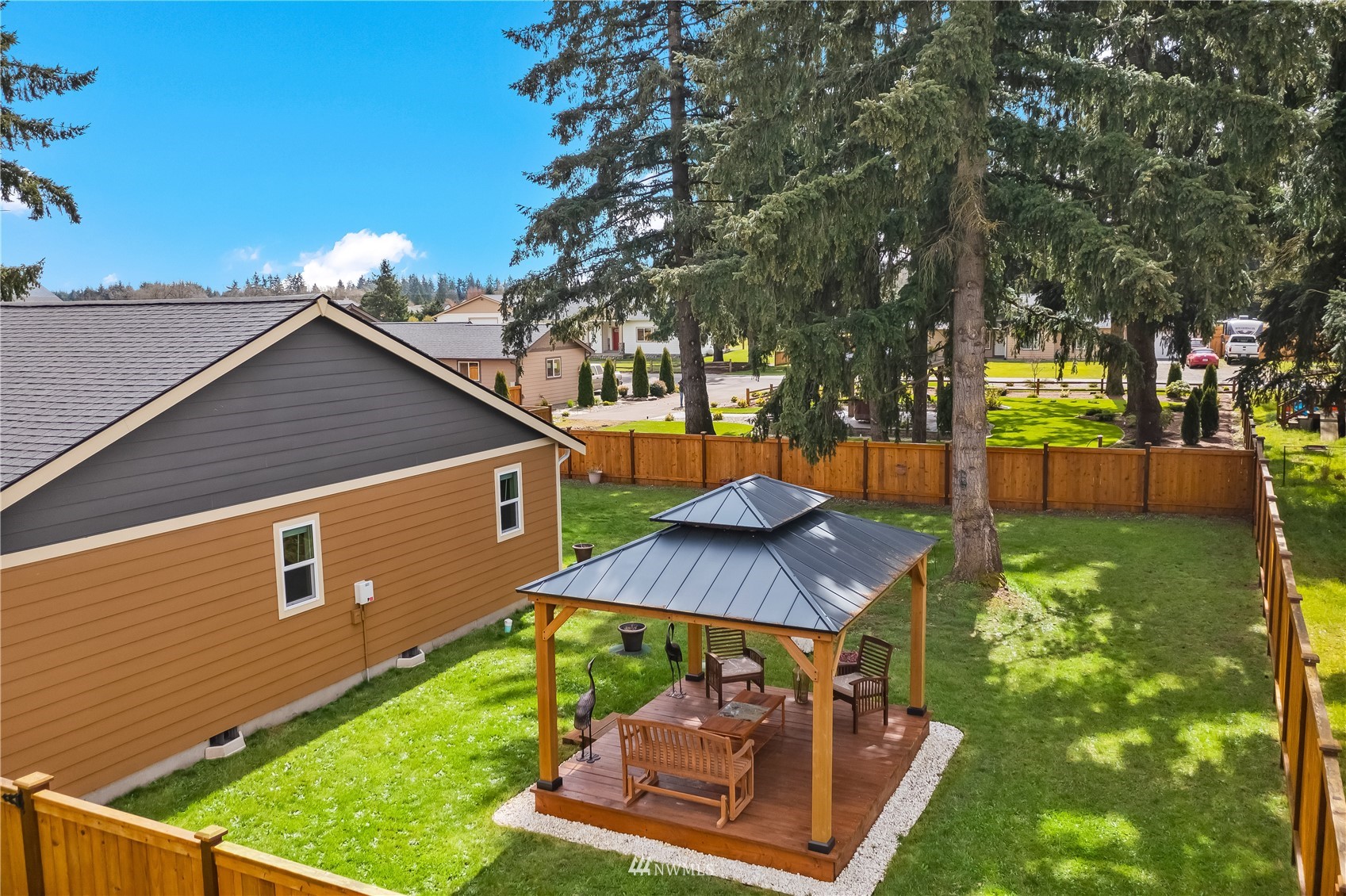 9249 179th Trail Southwest Rochester, WA 98579 - Photo 39 of 40 a view of a backyard with plants and a patio