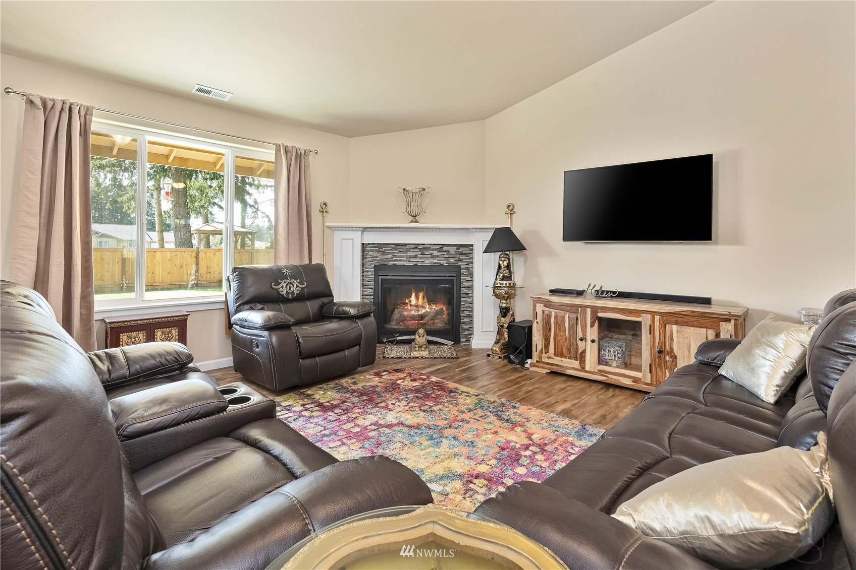 9249 179th Trail Southwest Rochester, WA 98579 - Photo 6 of 40 a living room with furniture a flat screen tv and a fireplace